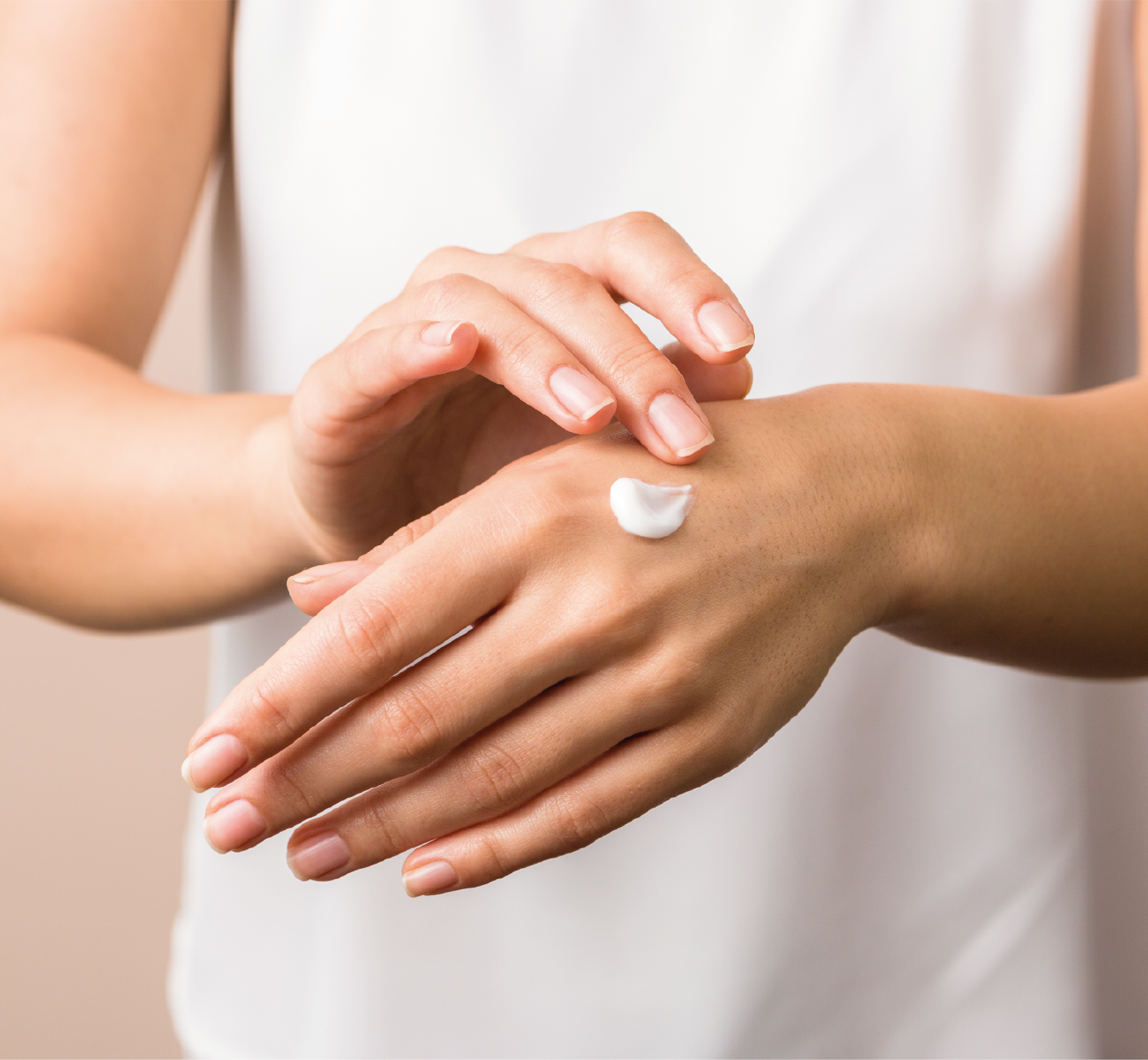 Woman applying cream to hand